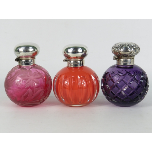 47 - Three antique coloured glass perfume bottles with sterling silver tops - cranberry etched floral glo... 