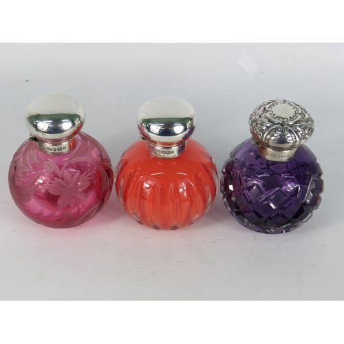 47 - Three antique coloured glass perfume bottles with sterling silver tops - cranberry etched floral glo... 