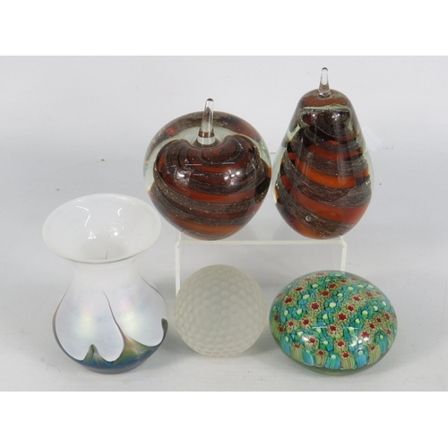 54 - Four glass paperweights and a small iridescent vase, including a Royal Doulton glass golf ball paper... 