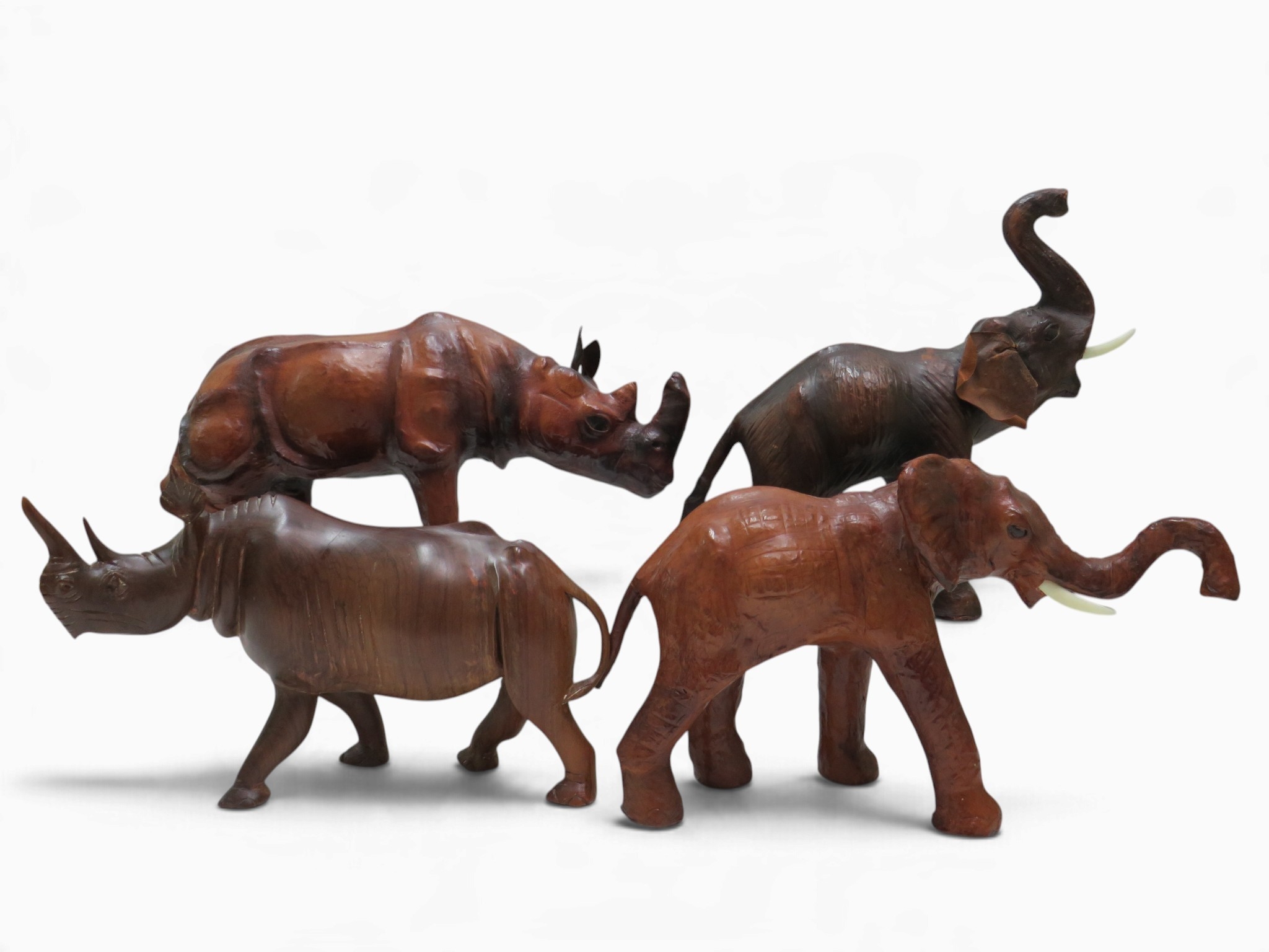 4 leather wrapped and wooden animal figurines - elephants and rhinos