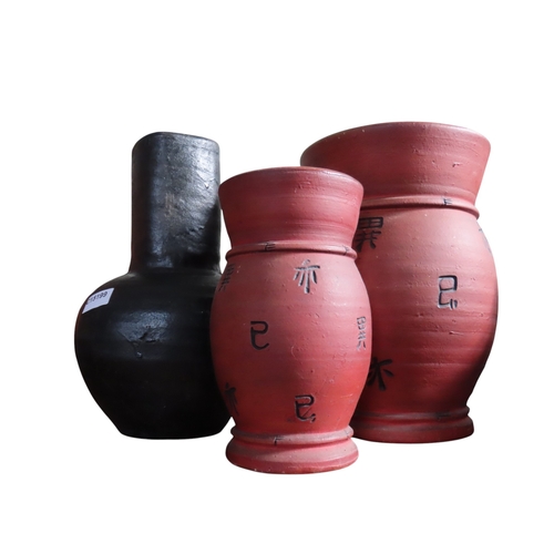 Three large decorative pottery vessels, comprising two red-finished ...