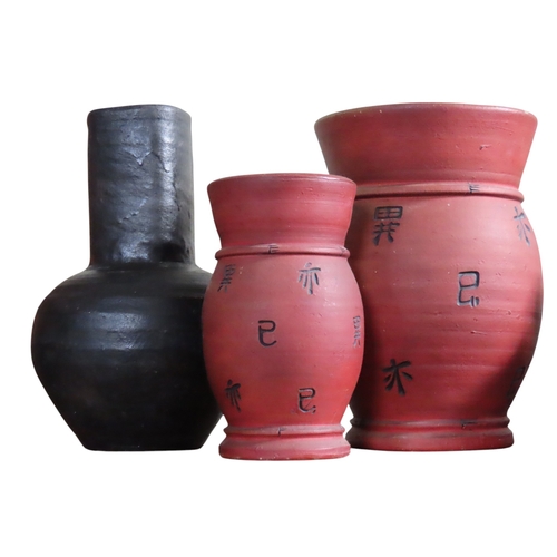 Three large decorative pottery vessels, comprising two red-finished ...