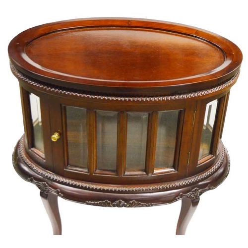 326 - An Oval Mahogany Display Cabinet