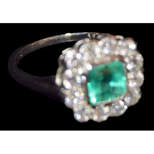 600 - A Platinum Diamond and Emerald Cluster Ring