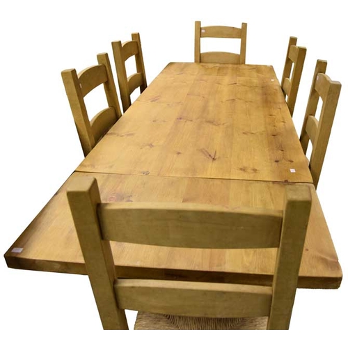 150 - A Very Good Extending Rectangular Pine Kitchen Table and Matching Six Chair Set with Rush Seats