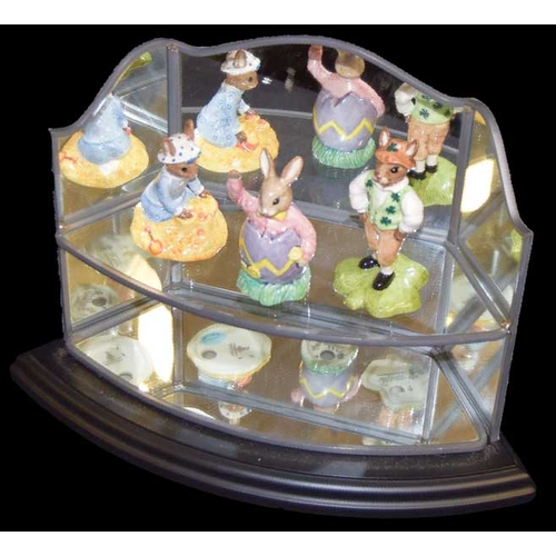 371 - A Set of Three Bunnykins Figurines and Their Mirror Backed Stand