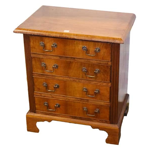 135 - A Small Walnut Four Drawer Chest