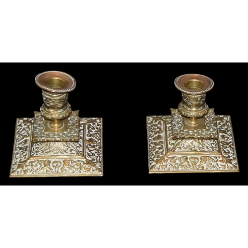 180 - A Pair of Embossed Brass Candlesticks