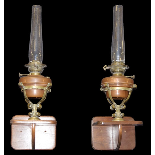 40 - A Pair of Oil Lamps and Stands on Mahogany Brackets