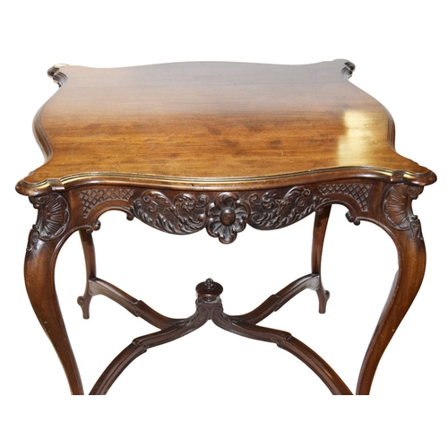 603 - An Ornately Carved Mahogany Window Table