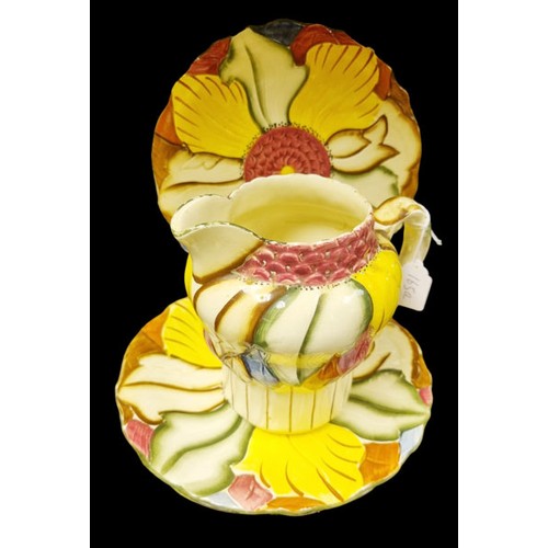 165A - An Art Deco Milk Jug and Three Similar Hand Painted Burslem Plates