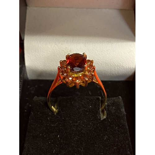 50 - 14ct gold ring size P featuring red stones, possibly ruby