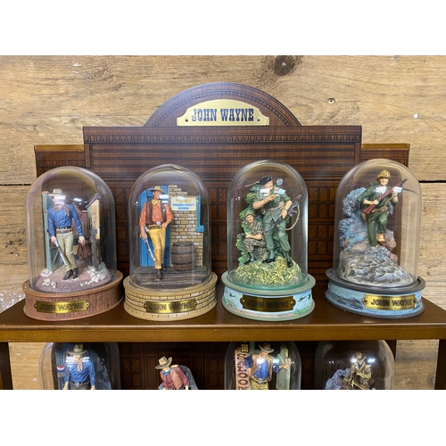 282 - Collection of Nine John Wayne Figures with Display Stand