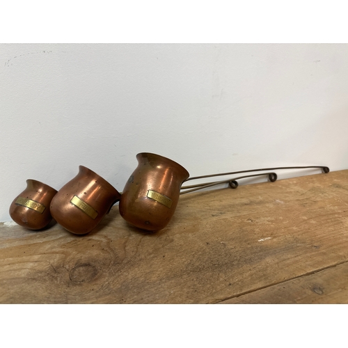 179 - Set of copper spirit measuring jugs