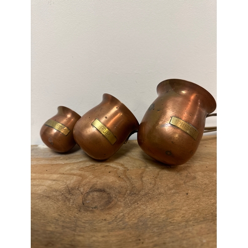 179 - Set of copper spirit measuring jugs