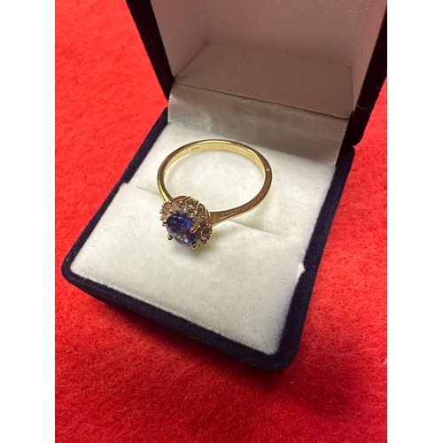 28 - Ladies 9ct Gold Ring with purple stone and Diamonds size P