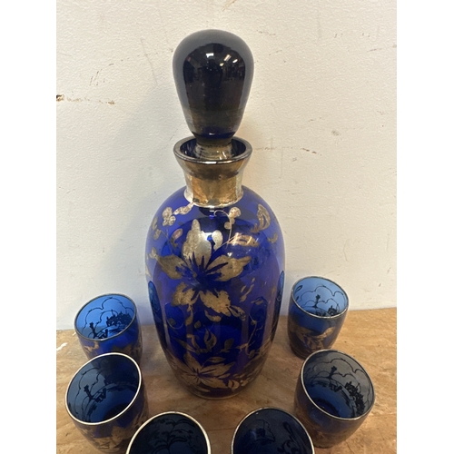 114 - Vintage blue glass drinks decanter and 6 matching glasses