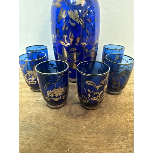 114 - Vintage blue glass drinks decanter and 6 matching glasses