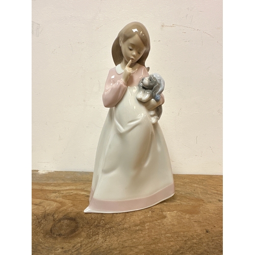 202 - NAO girl figurine holding a dog