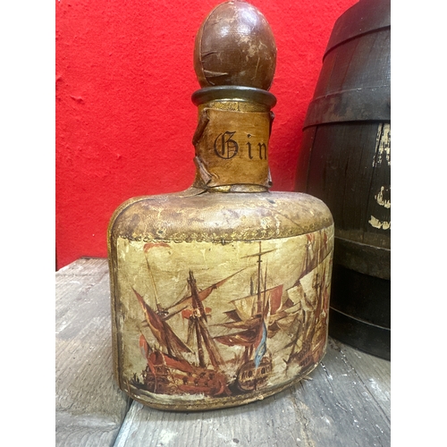 265 - Vintage oak Tanners sherry barrel and a old gin bottle with leather cover show a picture of old ship... 