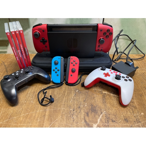 387 - Nintendo Switch console. Includes wiring, x 6 controllers, carry case and 4 games.