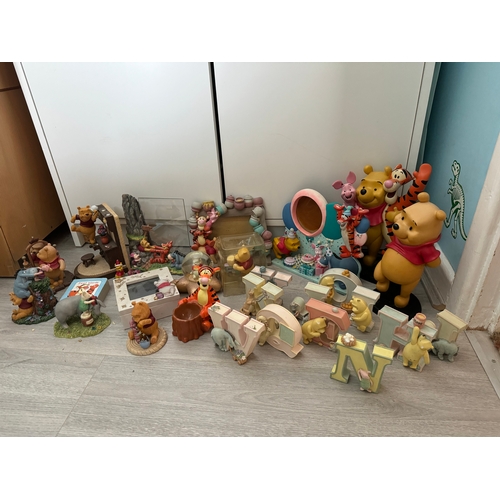 55 - Large collection of Winnie the Pooh figures and frames