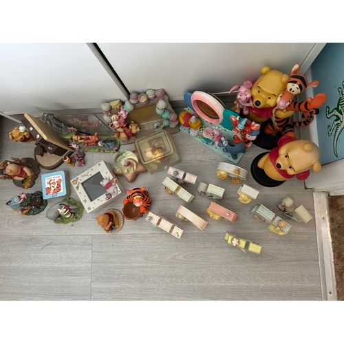 55 - Large collection of Winnie the Pooh figures and frames