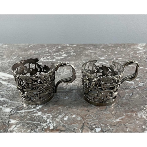 1321 - A pair of Japanese coffee cups in white metal mounts, possibly from Yokohama, the cups having floral... 