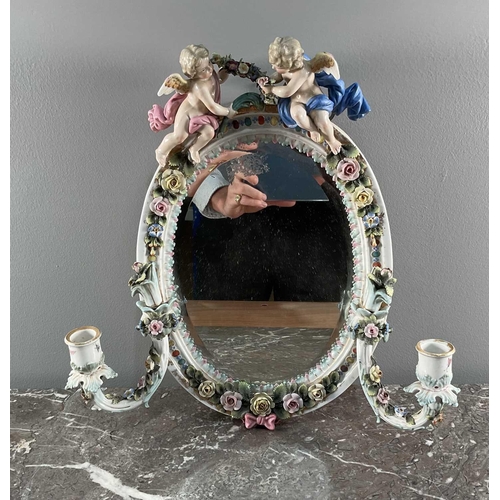 1232 - A Sitzendorf porcelain wall mirror, with twin candle sconces and floral encrusted border, surmounted... 