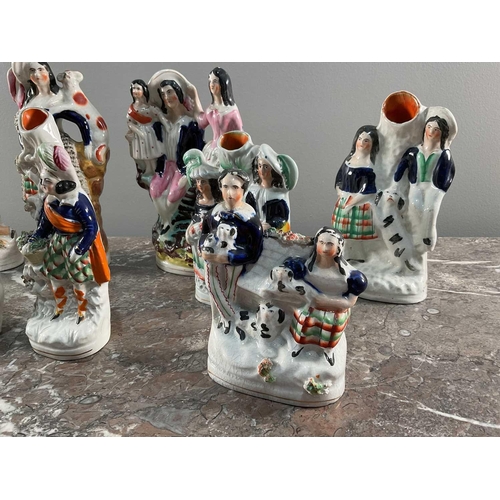 1243 - A collection of Staffordshire ceramics comprising nine peices, each modeled of figures, largest 23cm... 