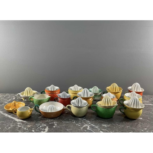 1244 - A collection of porcelain citrus juicers in the form of various fruits, by various makers.Generally ... 