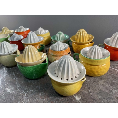 1244 - A collection of porcelain citrus juicers in the form of various fruits, by various makers.Generally ... 