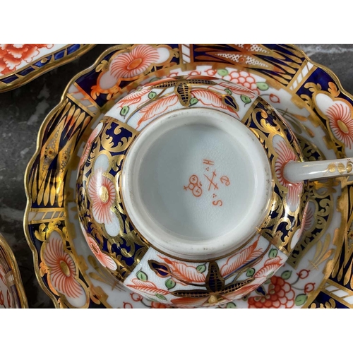 1261 - A collection of Royal Crown Derby Imari porcelain tableware comprising various plates, cups and sauc... 