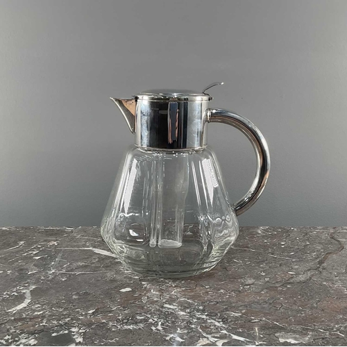 1278 - A 1950s jug officially licenced by Pimms, having silver tone handle and lid with glass insert and si... 