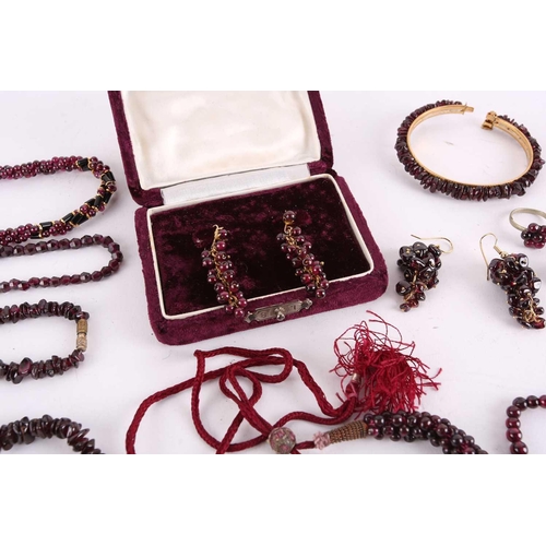 1296 - A large collection of garnet beaded jewellery; including four drawstring necklaces with adjustable c... 