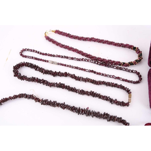 1296 - A large collection of garnet beaded jewellery; including four drawstring necklaces with adjustable c... 