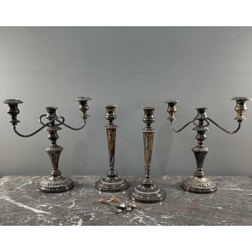 1319 - A collection of silver plated items comprising four candelabra and a set of teaspoons, largest 35cm.... 