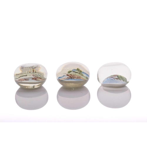 40 - A collection of three 'Chinese White' paperweights featuring landscape scenes of varying seasons, al... 