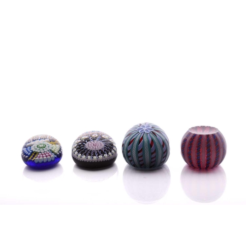 49 - Perthshire Paperweights; a collection of four weights comprising two with complex milifiori designs ... 