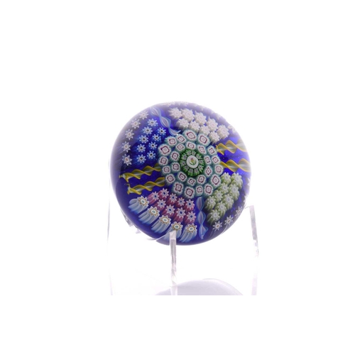 49 - Perthshire Paperweights; a collection of four weights comprising two with complex milifiori designs ... 
