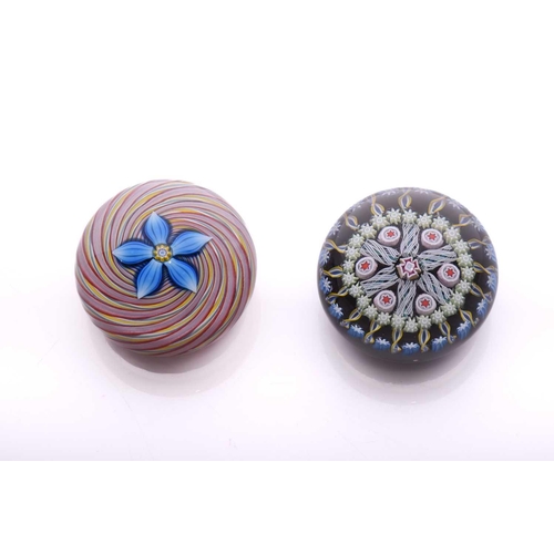 57 - Peter McDougall; two paperweights one having large central flower design with swirling ground and po... 