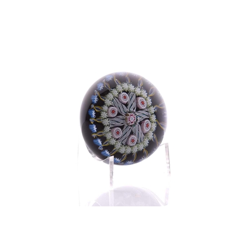 57 - Peter McDougall; two paperweights one having large central flower design with swirling ground and po... 