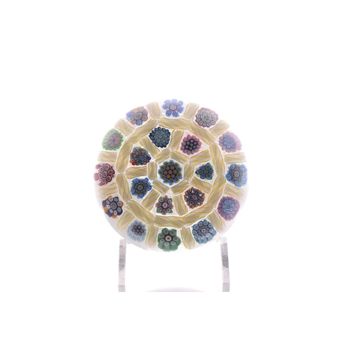 58 - Peter McDougall; a paperweight having millefiori design with latticino ground, having pollished base... 