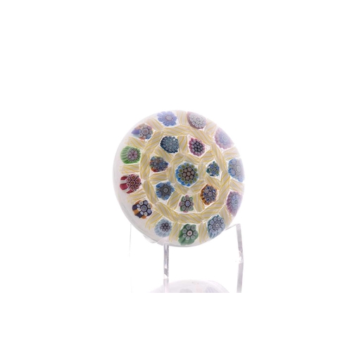 58 - Peter McDougall; a paperweight having millefiori design with latticino ground, having pollished base... 