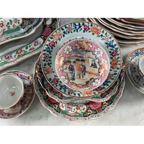 1226 - An Indian Ironstone tureen and cover with serving plate, 37.5 cm wide, in green and red, eight match... 