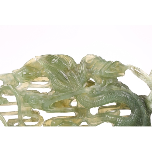 1235 - A contemporary Chinese variegated celadon jade carved and pierced study of two writhing dragons cont... 