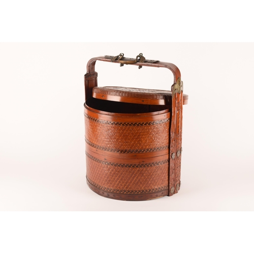 1238 - A Chinese food carrier with handle, made of lacquered straw with metal mounts and fixtures, 52cm. Ge... 