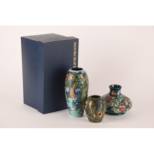 1274 - Three Moorcroft vases, one having peacock decoration, one floral on green ground and the largest hav... 