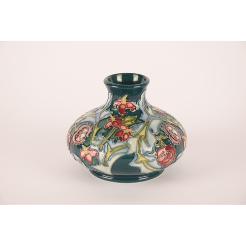 1274 - Three Moorcroft vases, one having peacock decoration, one floral on green ground and the largest hav... 