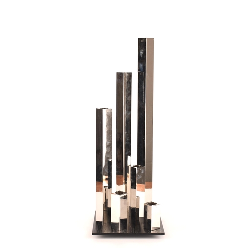 1253 - A set of six graduated chrome sculptural tealight holders on a wooden base, signed ER, 83cm. General... 